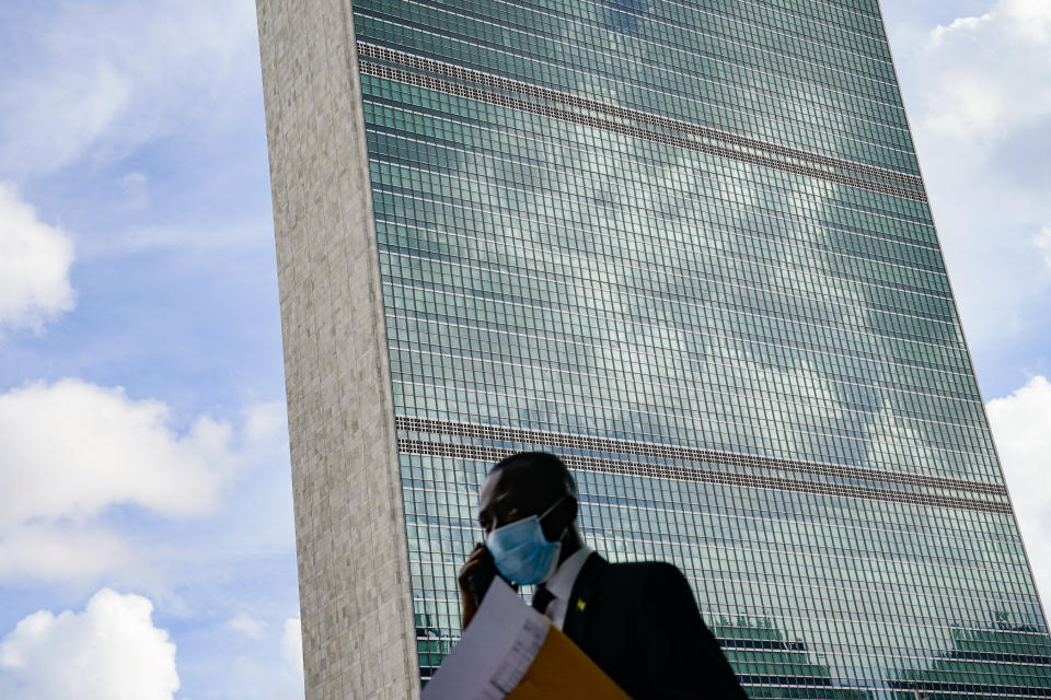 A pedestrian passes outside the United Nations headquarters, Tuesday, Sept. 21, 2021, during the 76th Session of the U.N. General Assembly in New York. (AP Photo/John Minchillo, Pool)