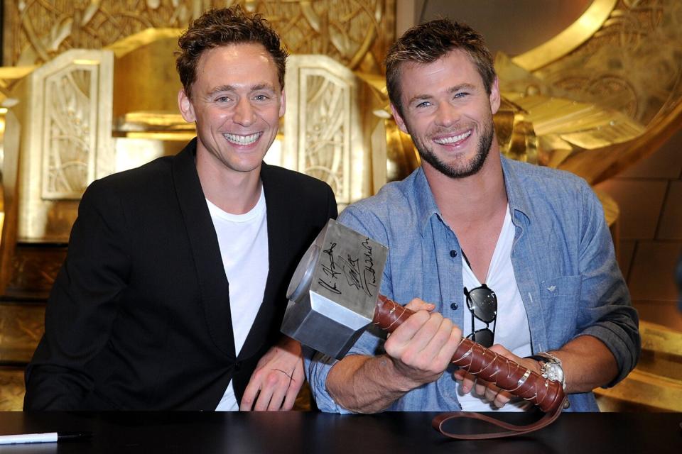 Actors Tom Hiddleston and Chris Hemsworth sign autographs during Comic-Con 2010 on July 24, 2010 in San Diego, California.