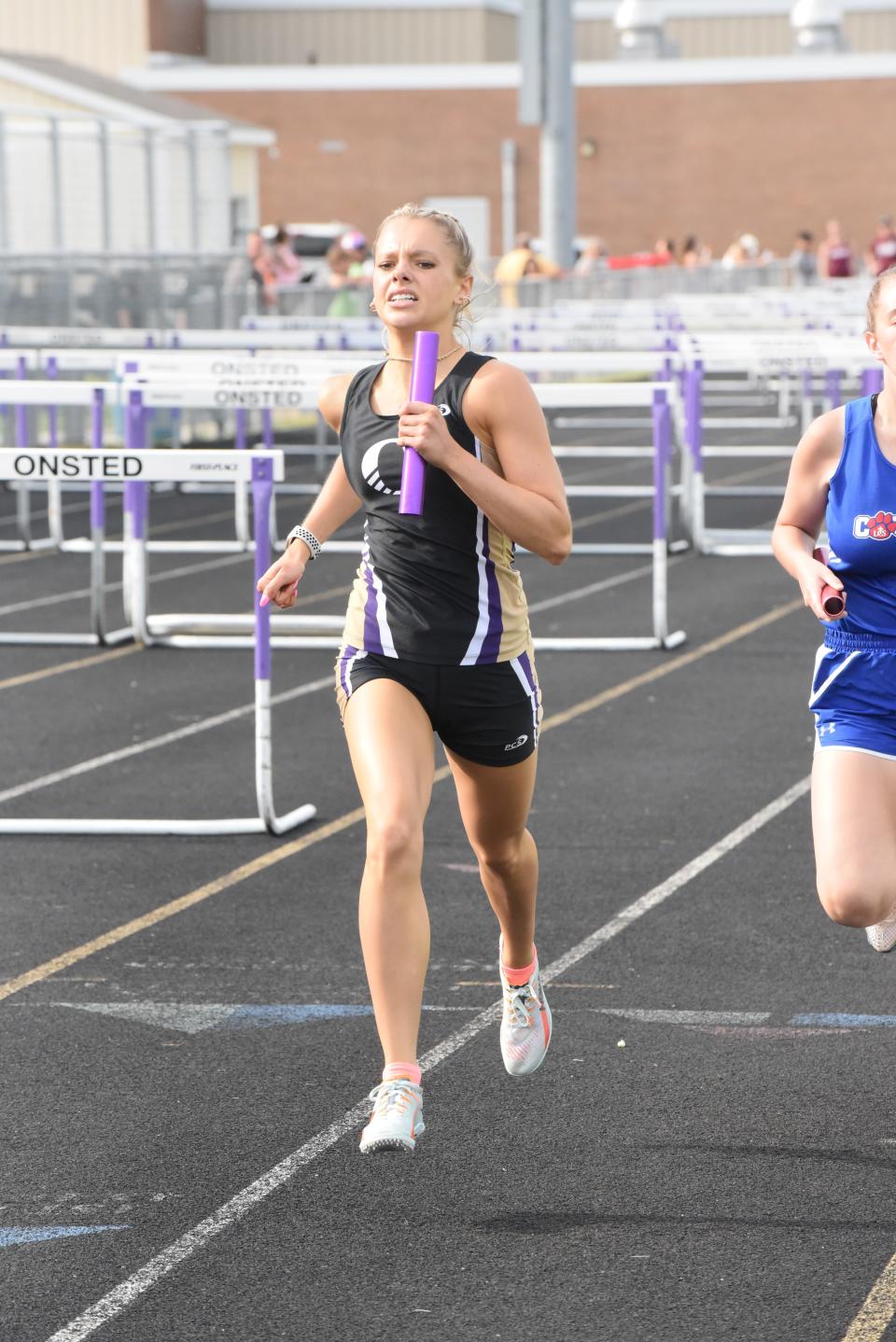Onsted's Kara Terakedis runs her leg of the 4x800 relay at the Lenawee County Track and Field Championships.