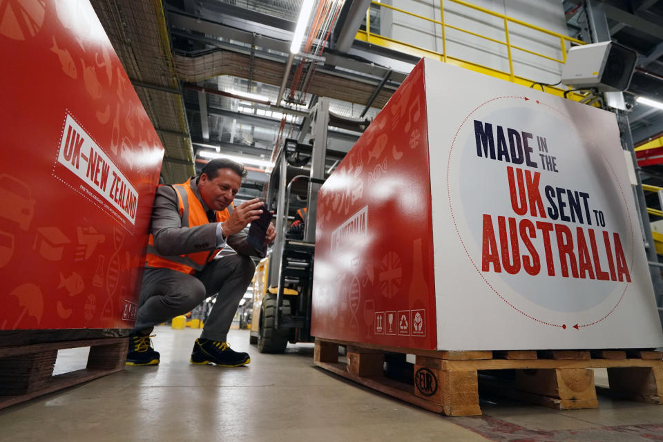 Trade minister Nigel Huddleston takes a photo during his visit to Heathrow's DHL facility as the UK's first post-Brexit trade deals with Australia and New Zealand come into effect on Wednesday. (PA)