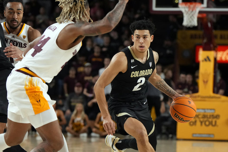 Colorado guard KJ Simpson (2) drives against Arizona State guard Adam Miller (44) during the first half of an NCAA college basketball game, Saturday, Jan. 6, 2024, in Tempe, Ariz. (AP Photo/Rick Scuteri)