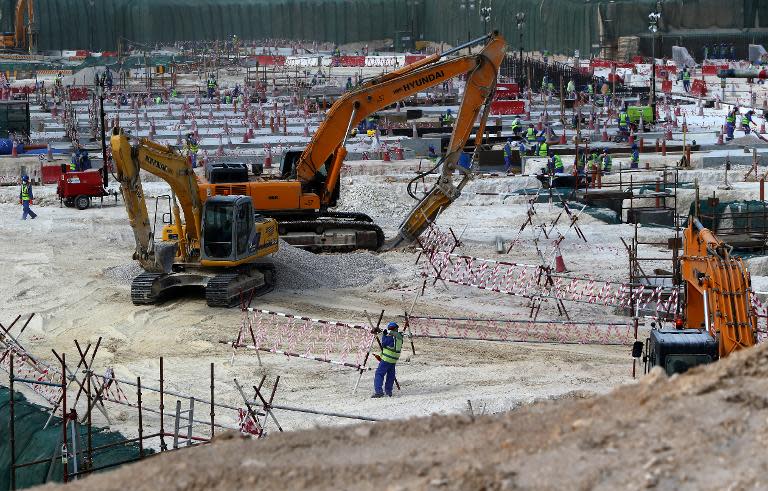 Foreign labourers work at the construction site of the al-Wakrah football stadium, one of Qatar's 2022 World Cup stadiums, on May 4, 2015, in Doha's southern suburbs