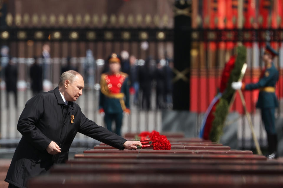 Russian President Vladimir Putin attends a wreath-laying ceremony at the Tomb of the Unknown Soldier after the military parade marking the 77th anniversary of the end of World War II in Moscow, Russia, Monday, May 9, 2022. (Anton Novoderezhkin, Sputnik, Kremlin Pool Photo via AP)