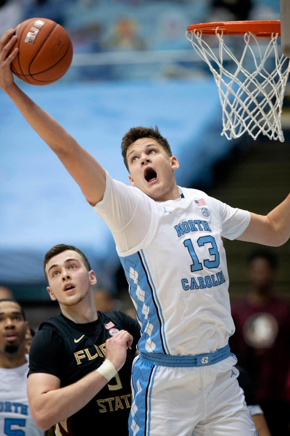 North Carolina’s Walker Kessler (13) secures an offensive rebound over Florida State’s Balsa Koprivica (5) during the first half on Saturday, February 27, 2021 in Chapel Hill, N.C.