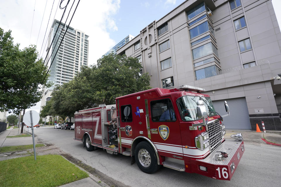 A Houston firetruck drives past the Chinese Consulate Thursday, July 23, 2020, in Houston. China says “malicious slander" is behind an order by the U.S. government to close its consulate in Houston, and maintains that its officials have never operated outside ordinary diplomatic norms. (AP Photo/David J. Phillip)