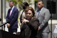 Acting United States Attorney Tracy Wilkison, center, fields questions outside the Edward R. Roybal Federal Building, Thursday, May 13, 2021, in Los Angeles. Federal authorities say they have arrested at least 10 suspected drug dealers accused of selling fentanyl and other opioids that led to overdose deaths. (AP Photo/Marcio Jose Sanchez)