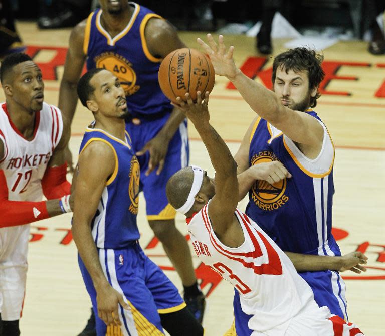 Corey Brewer of the Houston Rockets is blocked by Andrew Bogut of the Golden State Warriors during Game Three of the Western Conference Finals at Toyota Center on May 23, 2015 in Houston, Texas