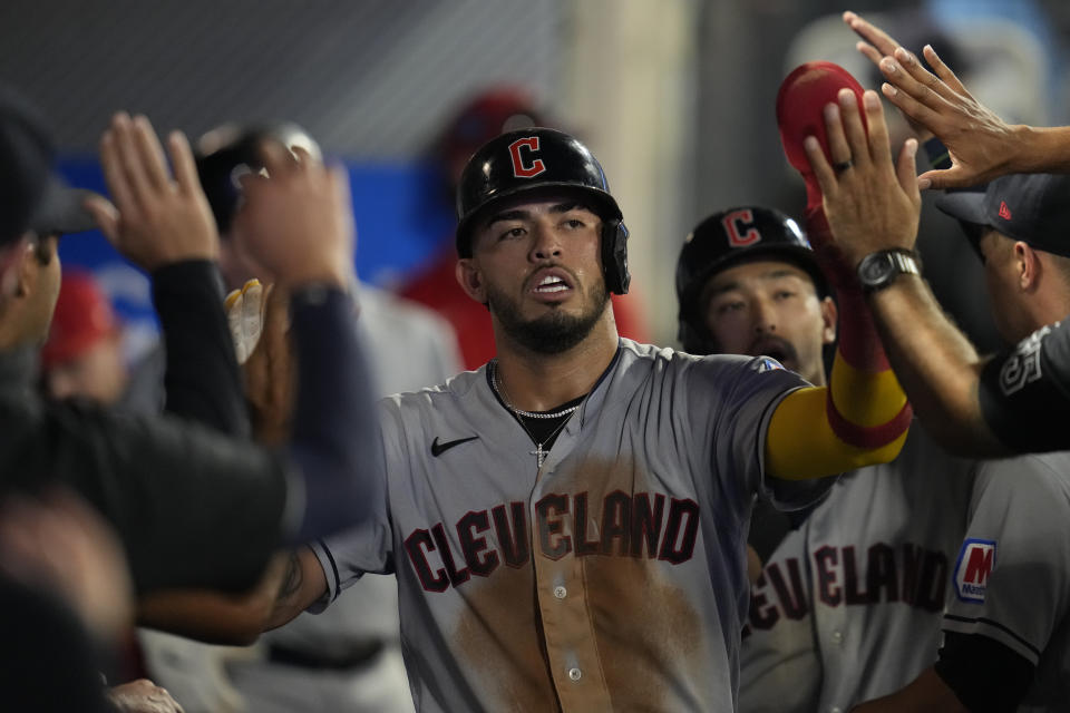 Cleveland Guardians' Gabriel Arias scores celebrates in the dugout after scoring off of a sacrifice fly hit by Steven Kwan during the sixth inning of a baseball game against the Los Angeles Angels in Anaheim, Calif., Friday, Sept. 8, 2023. (AP Photo/Ashley Landis)