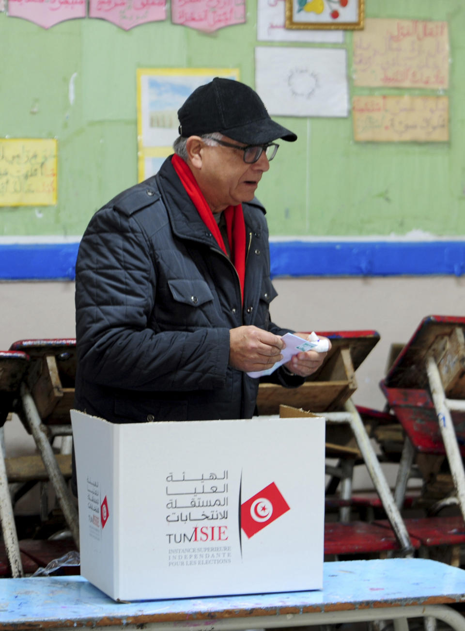 A Tunisian votes in the second round of the legislative elections in Tunis, Sunday, Jan. 29, 2023. Tunisia's president and its shaky democracy are facing an important test Sunday as voters cast ballots in the second round of parliamentary elections. Turnout was just 11% in the first round of voting last month. (AP Photo/Hassene Dridi)