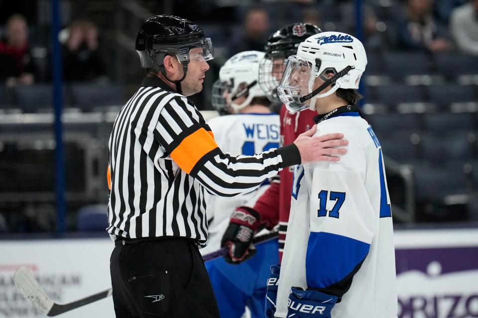 A referee pats Olentangy Liberty's Vinny Rengel on the arm during the second period of the 2023 state championship hockey game.