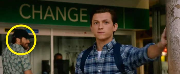 Peter standing next to a pillar with Quentin Beck in the background in "Spider-Man: Far From Home"
