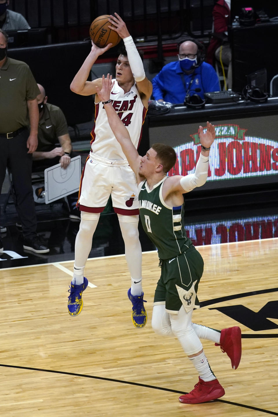 Miami Heat guard Tyler Herro (14) attempts a 3-point basket as Milwaukee Bucks guard Donte DiVincenzo (0) defends during the first half of an NBA basketball game Wednesday, Dec. 30, 2020, in Miami. (AP Photo/Lynne Sladky)