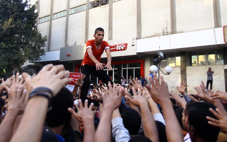 Demonstrators protest in front of the presidential palace in Cairo, Egypt, Saturday, April 26, 2014. Hundreds of secular-minded activists and protesters rallied in front of the presidential palace Saturday, demanding the interim president abolish a disputed protest law used extensively over the past months to jail and prosecute activists, including leading figures of the 2011 uprising that toppled longtime autocrat Hosni Mubarak. (AP Photo/Ahmed Gomaa)