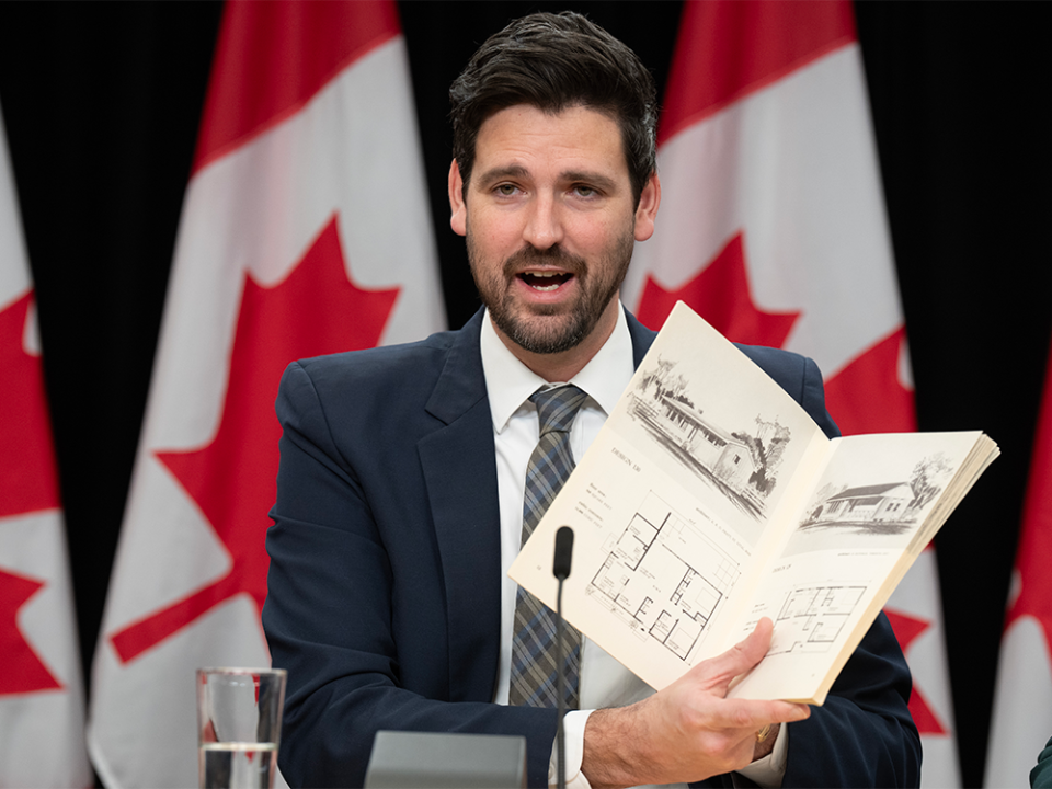  Minister of Housing, Infrastructure and Communities Sean Fraser holds ups booklet of housing plans during a news conference, Tuesday, Dec. 12, 2023 in Ottawa.