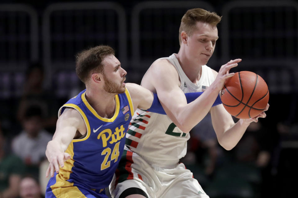 Pittsburgh guard Ryan Murphy (24) defends against Miami forward Sam Waardenburg during the first half of an NCAA college basketball game, Sunday, Jan. 12, 2020, in Coral Gables, Fla. (AP Photo/Lynne Sladky)