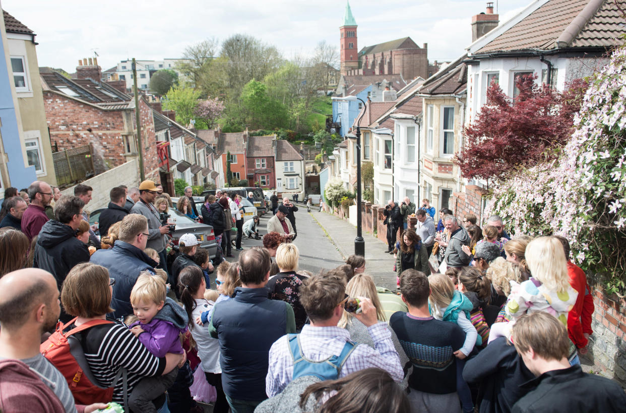 Vale Street, in Bristol, which is officially England's steepest street - according to Ordnance Survey. Pictured crowds have gathered for the annual egg rolling competition. (SWNS)