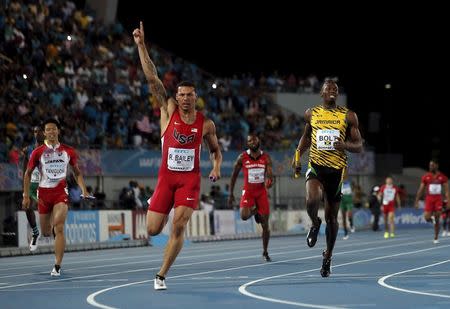 Ryan Bailey of the U.S. (C) celebrates as he crosses the finish line ahead of Jamaica's Usain Bolt (L) as the U.S. won the 4x100 meters race at the IAAF World Relays Championships in Nassau, Bahamas, May 2, 2015. Japan's Kataro Taniguchi is at left. REUTERS/Mike Segar