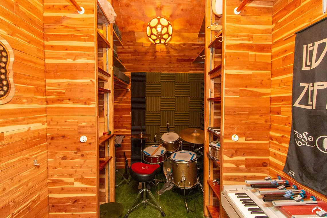 This cedar closet was converted into a drum room. An interior window connects it to an adjoining control room.