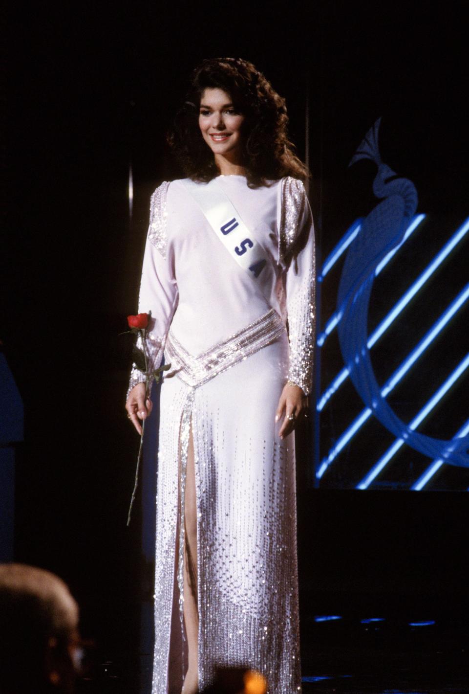 Miss USA 1985 Laura Harring poses in an evening gown and her sash.