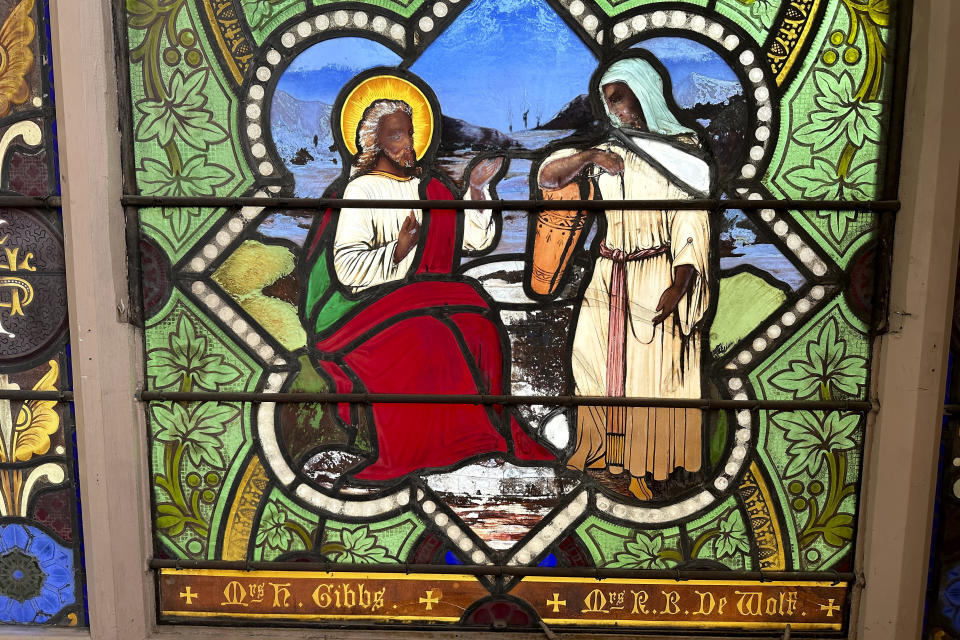 A detail of a nearly 150-year-old stained-glass window depicts Christ speaking to a Samaritan woman, in the now-closed St. Mark's Episcopal church, Monday, May 1, 2023, in Warren, R.I. The nearly 150-year-old stained-glass window from the Rhode Island church that depicts Christ and three New Testament women with dark skin has stirred up questions about race and the place of women in both biblical and 19th century society. (AP Photo/Mark Pratt)