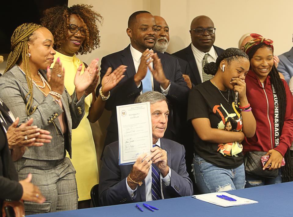 Governor John Carney was joined by legislators and members of the community Monday afternoon in signing two major police reform bills into law in Wilmington.