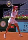 Iga Swiatek of Poland returns the ball to Sara Sorribes of Spain during the Mutua Madrid Open tennis tournament in Madrid, Spain, Monday, April 29, 2024. (AP Photo/Manu Fernandez)