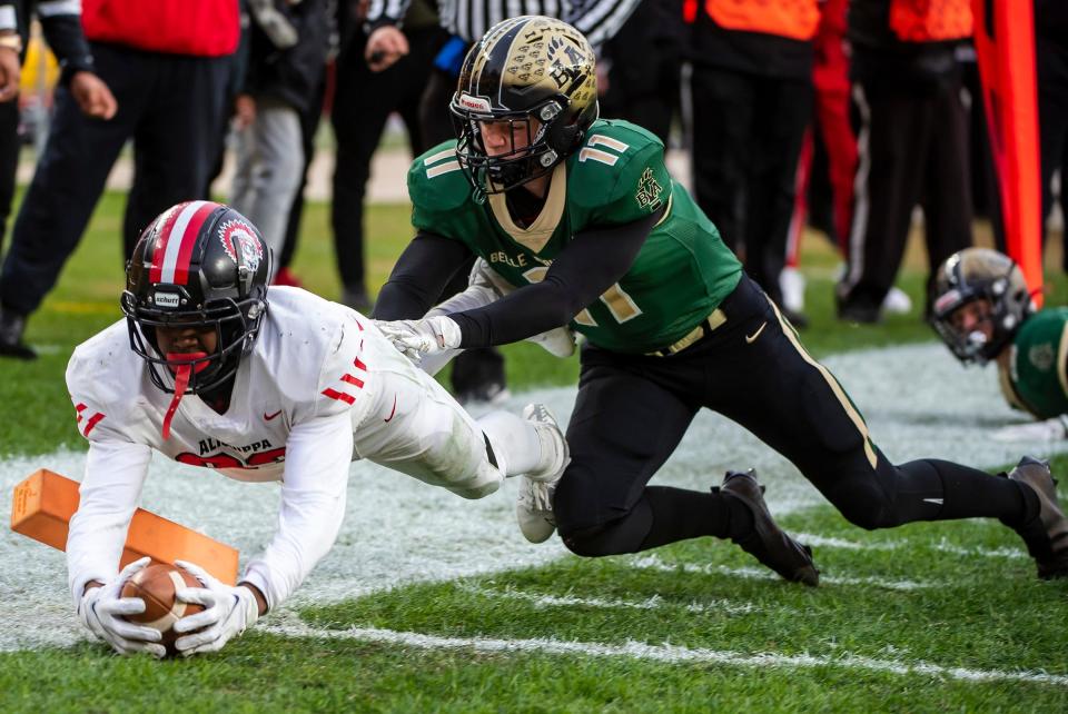 Aliquippa's Tiqwai Hayes dives into the endzone past Belle Vernon's Reilly Wiant for his second touchdown in the WPIAL 4A Championship Saturday at Heinz Field.[Lucy Schaly/For BCT]