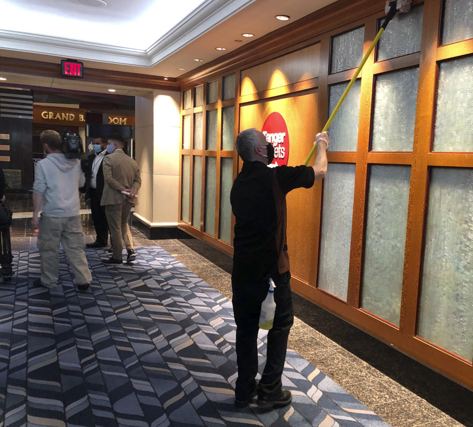 In this May 22, 2020 photo, a maintenance employee cleans the walls at Foxwoods Resort Casino in Mashantucket, Connecticut. It's part of the casino's stepped up cleaning regimen, in advance of a planned partial reopening on June 1. Both the tribal-owned Foxwoods and Mohegan Sun are pushing ahead with plans to open parts of their resorts on tribal lands, despite opposition from Connecticut Gov. Ned Lamont. Foxwoods officials say only 25% of the sprawling resort will be reopened initially. (AP Photo/Susan Haigh)