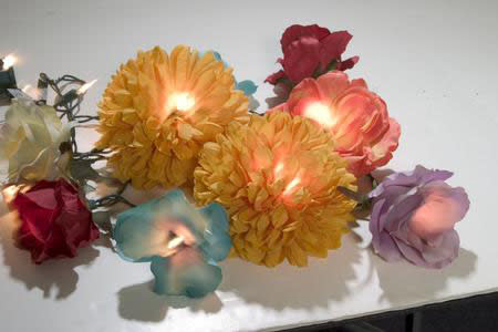 I love this idea from Crafty Chica. Create floral fantasy lights with fairy lights and silk flowers.