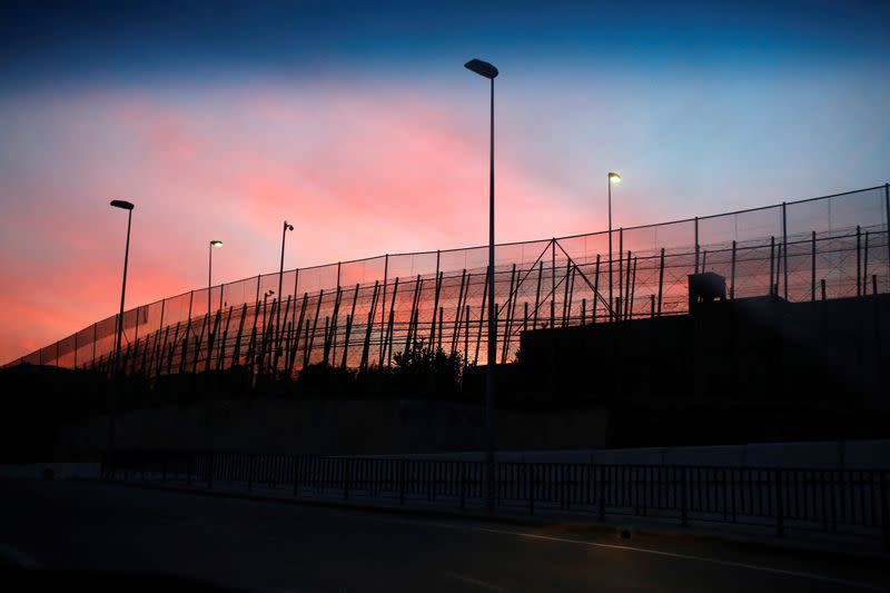The border fence between Morocco and Spain's north African enclave Melilla is seen along a road