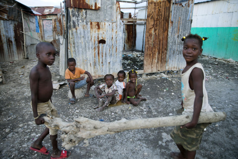 In this Dec. 3, 2019 photo, children play near their home in the Cite Soleil slum of Port-au-Prince, Haiti. According to a joint statement by humanitarian organizations, an estimated 3.7 million Haitians require emergency food assistance. (AP Photo/Dieu Nalio Chery)