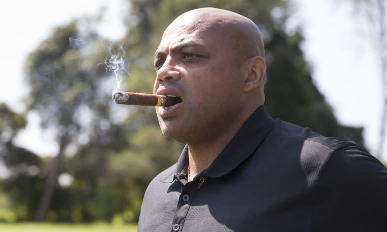 Charles Barkley smokes a cigar.