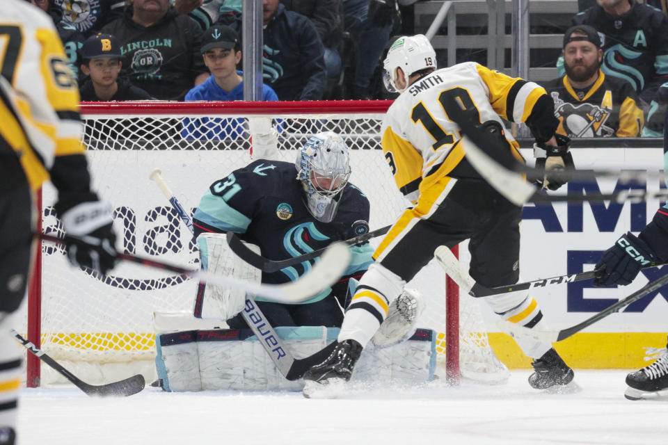 Pittsburgh Penguins right wing Reilly Smith (19) tries to score against Seattle Kraken goaltender Philipp Grubauer (31) during the first period of an NHL hockey game Thursday, Feb. 29, 2024, in Seattle. (AP Photo/Jason Redmond)