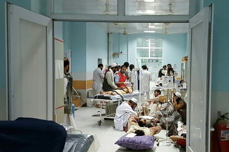 In this photograph released by MSF on October 3, 2015, Afghan MSF personnel treat civilians injured following an offensive against Taliban militants by Afghan and coalition forces at the MSF hospital in Kunduz