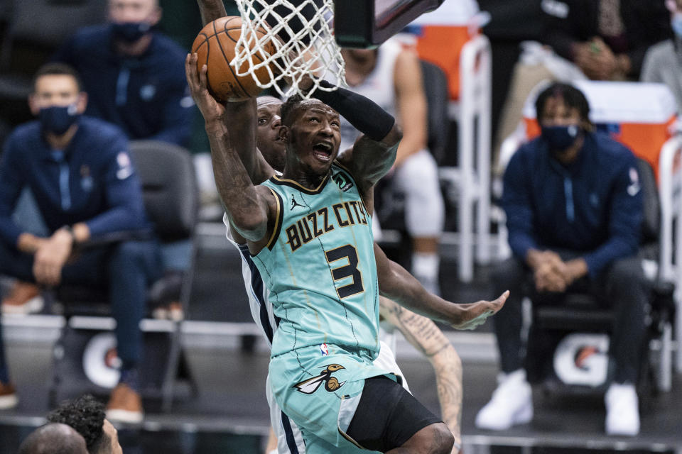 Charlotte Hornets guard Terry Rozier (3) drives to the basket while being guarded by Memphis Grizzlies center Gorgui Dieng during the first half of an NBA basketball game in Charlotte, N.C., Friday, Jan. 1, 2021. (AP Photo/Jacob Kupferman)