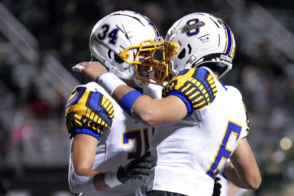 Olentangy’s Kaden Gebhardt (34) celebrates with teammate Ethan Grunkemeyer (6) after scoring a touchdown against Dublin Jerome in a Division I first-round playoff game Oct. 28.