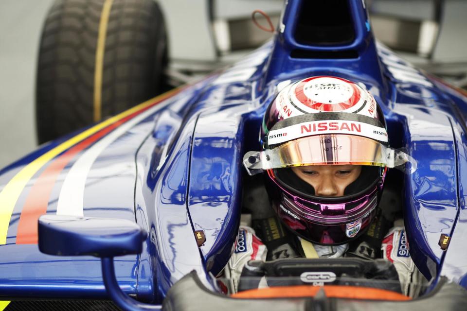 A man in a race car concentrates.