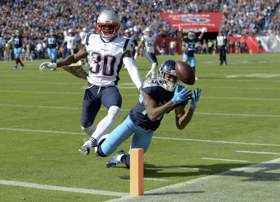 Tennessee Titans wide receiver Tajae Sharpe (19) can't hang onto a pass as he is defended by New England Patriots cornerback Jason McCourty (30) in the first half of an NFL football game Sunday, Nov. 11, 2018, in Nashville, Tenn. (AP Photo/Mark Zaleski)