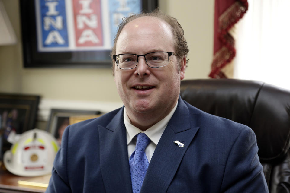 State Democratic Party Chairman Wayne Goodwin speaks with an aide in his office at the Democratic party headquarters in Raleigh, N.C., Friday, April 5, 2019. Goodwin spoke to The Associated Press on Friday in his first interview since federal bribery and conspiracy charges were lodged against donor Greg Lindberg and state Republican Party Chairman Robin Hayes. (AP Photo/Gerry Broome)