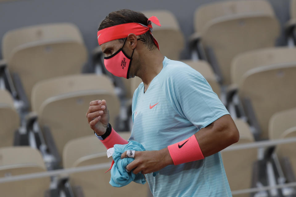 Spain's Rafael Nadal wears a face mask during a break in the first round match of the French Open tennis tournament against Egor Gerasimov of Belarus at the Roland Garros stadium in Paris, France, Monday, Sept. 28, 2020. (AP Photo/Alessandra Tarantino)