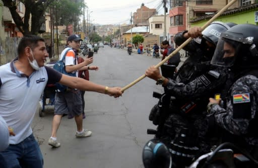 Bolivian pro-government supporters clash with riot police during a rally for President Evo Morales in Cochabamba