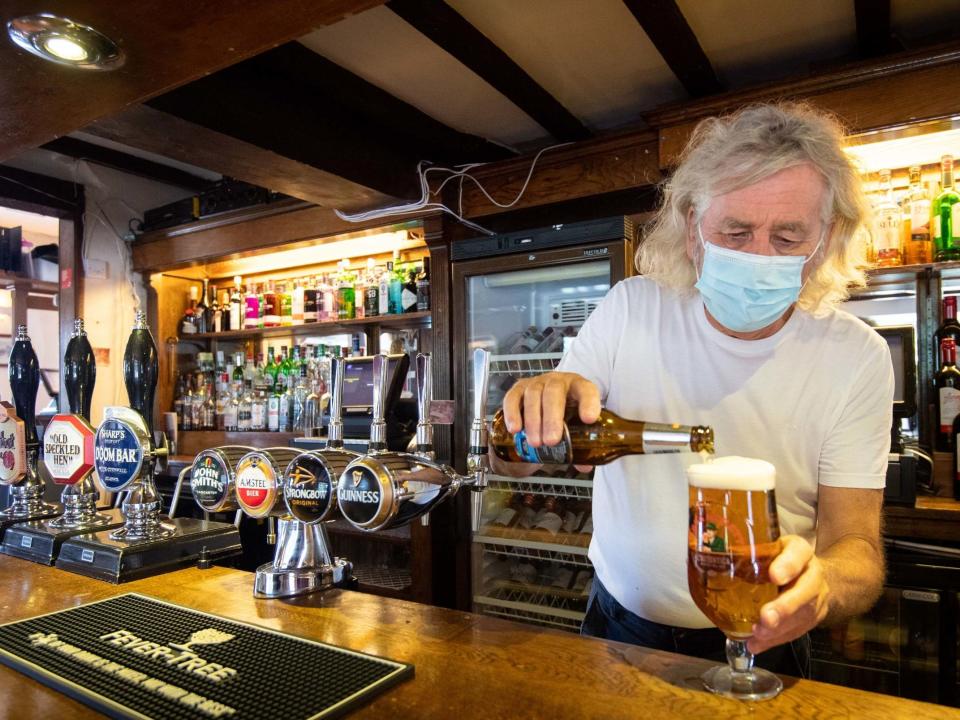 Phil Weaver, owner of The Old Smith in Church Lawford, Warwickshire, pours a drink as pub and hospitality bosses have cheered the government's proposals to allow customers through their doors again: PA