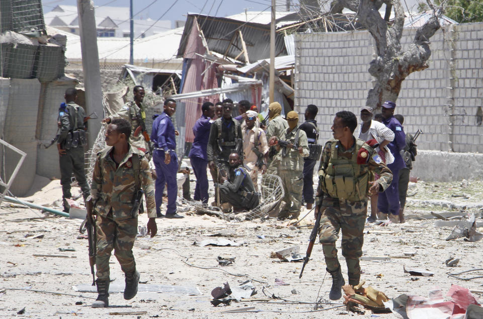 Somali government soldiers run to take positions during ongoing fighting with gunmen, after a suicide car bomb attack on a government building in the capital Mogadishu, Somalia, Saturday, March 23, 2019. Al-Shabab gunmen stormed into the government building following a suicide car bombing at the gates on Saturday, a police officer said, in the latest attack by Islamic extremist fighters in the Horn of Africa nation. (AP Photo/Farah Abdi Warsameh)