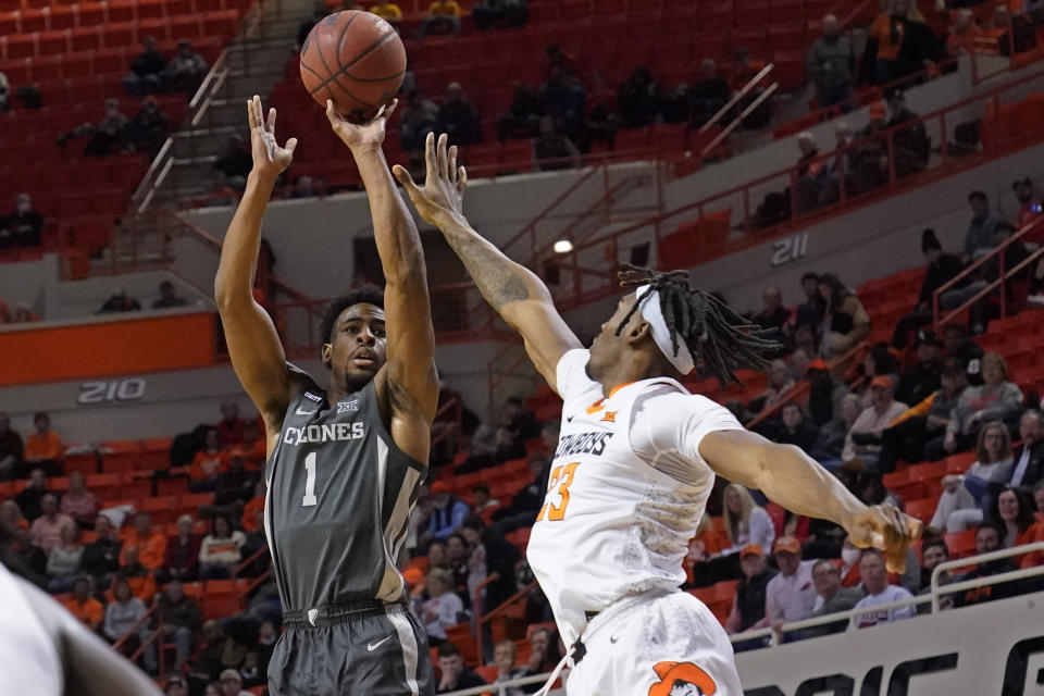 Iowa State guard Izaiah Brockington (1) shoots over Oklahoma State forward Tyreek Smith ()23) in the first half of an NCAA college basketball game Wednesday, Jan. 26, 2022, in Stillwater, Okla. (AP Photo/Sue Ogrocki)