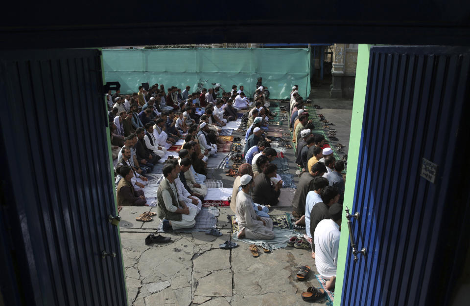 Afghan Muslims offer Eid al-Adha prayers in Kabul, Afghanistan, Sunday, Aug. 11, 2019. Muslim people in the country celebrate Eid al-Adha, or the Feast of the Sacrifice by slaughtering sheep, goats and cows whose meat will later be distributed to the poor. (AP Photo/Rafiq Maqbool)