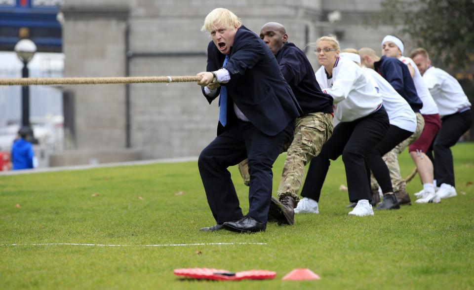 Mayor of London Boris Johnson (left) takes part in a tug of war with personnel from the Royal Navy, the Army and the Royal Air Force at the launch of London Poppy Day, on Potters Field, next to City Hall in London.