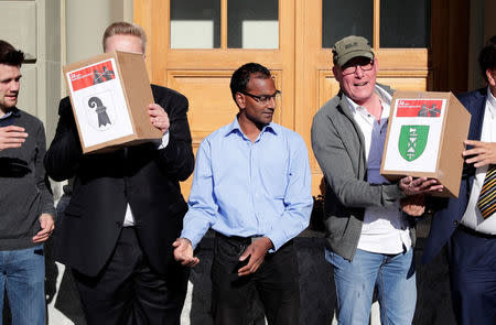 Members of the initiative committee for "Yes to a Mask Ban" (Ja zum Verhuellungsverbot), hand over boxes containing more than 100,000 signatures collected that are required to put the proposal of a ban on facial coverings worn by some Muslim women to a national vote, at the Federal Chancellery in Bern, Switzerland September 15, 2017. REUTERS/Moritz Hager