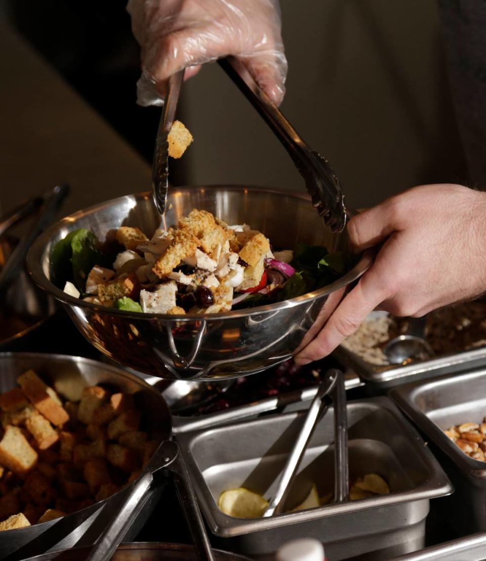 Josh Reynolds fixed a salad order at Vinaigrette Salad Kitchen on Sharkey Way in the Townley Center development in Lexington, Ky., on April 21, 2015.