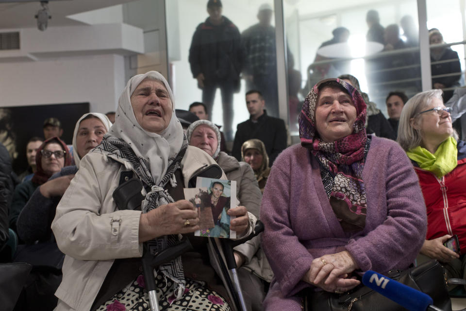 Relatives of victims of the Srebrenica genocide weep as they hear news on the decision of the UN appeals judges on former Bosnian Serb leader Radovan Karadzic in Potocari, Bosnia and Herzegovina, Wednesday, March 20, 2019. United Nations appeals judges on Wednesday upheld the convictions of Karadzic for genocide, war crimes and crimes against humanity, and increased his sentence from 40 years to life imprisonment. (AP Photo/Marko Drobnjakovic)