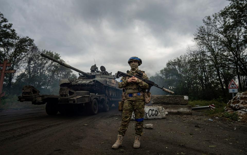 A Ukrainian serviceman stands at the checkpoint near the recently retaken area of Izium, Ukraine, Thursday, Sept. 15, 2022 - Evgeniy Maloletka/ AP